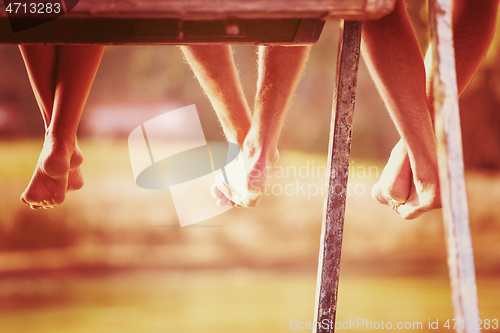 Image of people sitting at wooden bridge