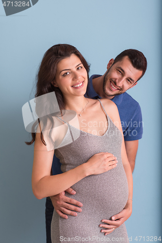 Image of pregnant couple  isolated over blue background