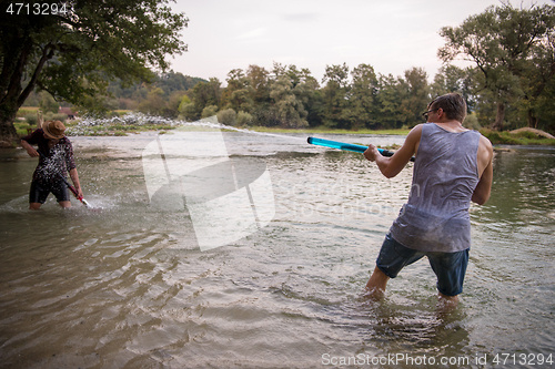 Image of young men having fun with water guns