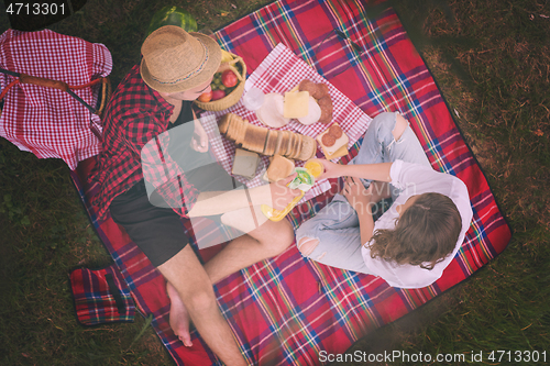 Image of top view of couple enjoying picnic time