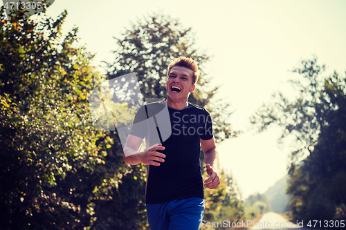 Image of man jogging along a country road