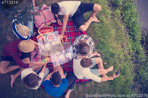 Image of top view of group friends enjoying picnic time