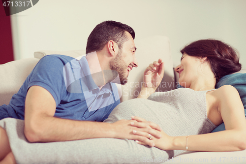 Image of future dad listening the belly of his pregnant wife