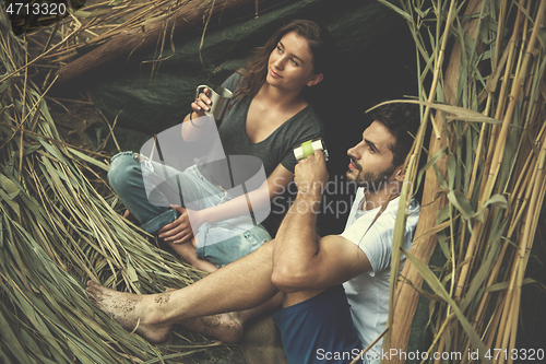 Image of couple spending time together in straw tent