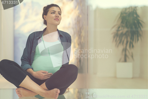Image of pregnant women sitting on the floor