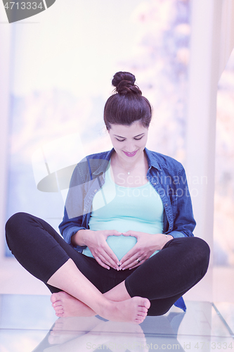 Image of pregnant women sitting on the floor