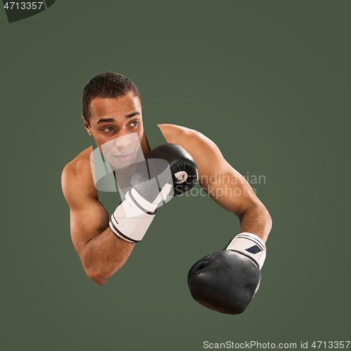 Image of Sporty man during boxing exercise. Photo of boxer on green background