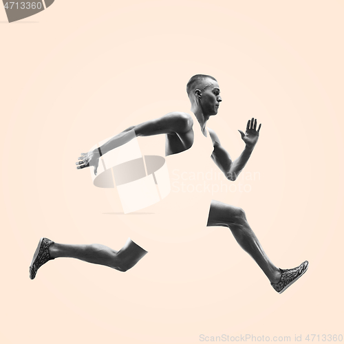 Image of Young caucasian man running or jogging isolated on studio background.