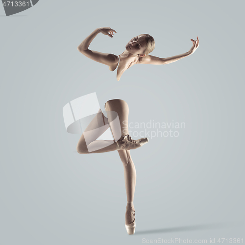 Image of Ballerina. Young graceful female ballet dancer dancing over grey studio. Beauty of classic ballet.