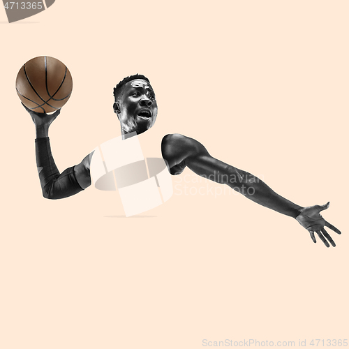 Image of Full length portrait of a basketball player with ball