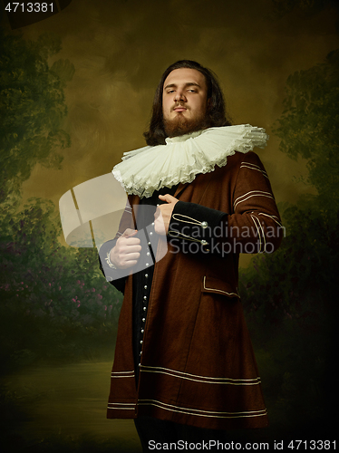 Image of Young man as a medieval knight on dark background