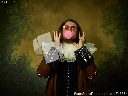 Image of Young man as a medieval knight on dark background