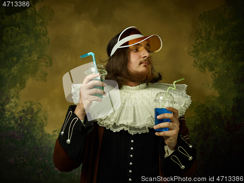 Image of Young man as a medieval knight on dark background