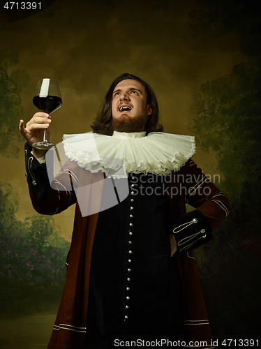 Image of Young man as a medieval knight on dark background