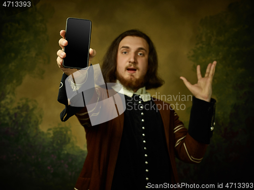 Image of Young man as a medieval knight on dark background