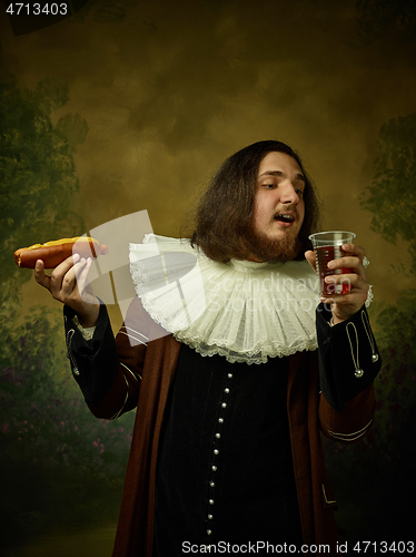 Image of Young man as a medieval knight on dark background