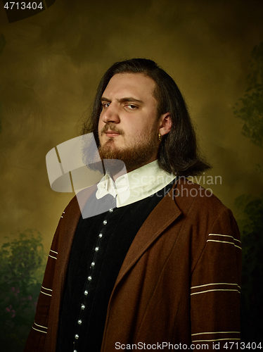 Image of Young man as a medieval knight on dark background