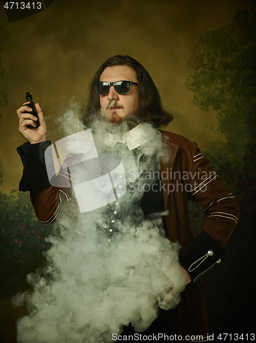 Image of Young man as a medieval knight on dark background