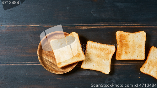 Image of toasted bread slices on rustic wooden table