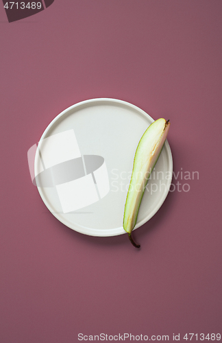 Image of abstract flat lay composition with plate and pear slice