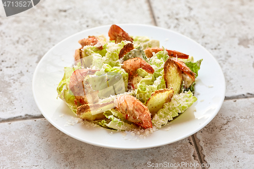 Image of portion of cesar salad with grilled prawns