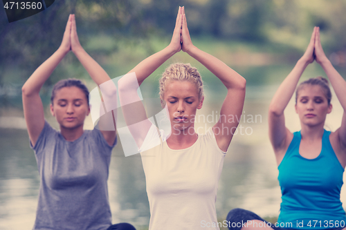 Image of women meditating and doing yoga exercise