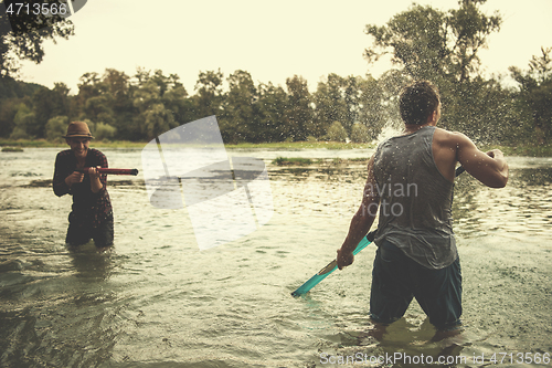 Image of young men having fun with water guns