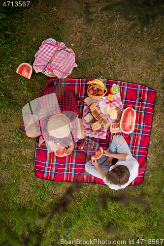 Image of top view of couple enjoying picnic time