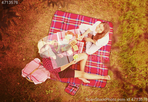 Image of top view of couple enjoying picnic time