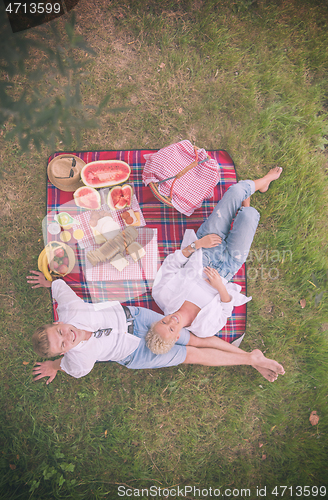 Image of top view of couple enjoying picnic time