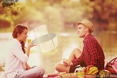 Image of Couple in love enjoying picnic time