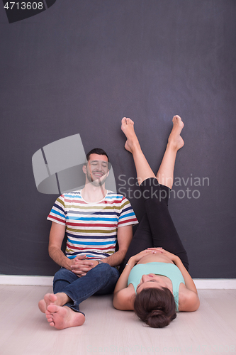 Image of pregnant couple relaxing on the floor