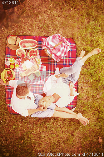 Image of top view of couple enjoying picnic time