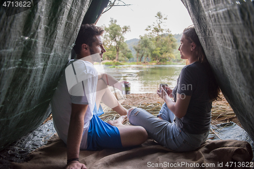 Image of couple spending time together in straw tent