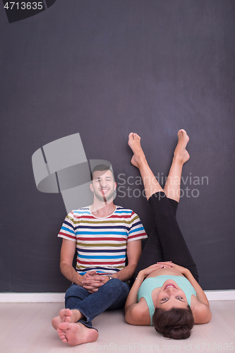 Image of pregnant couple relaxing on the floor