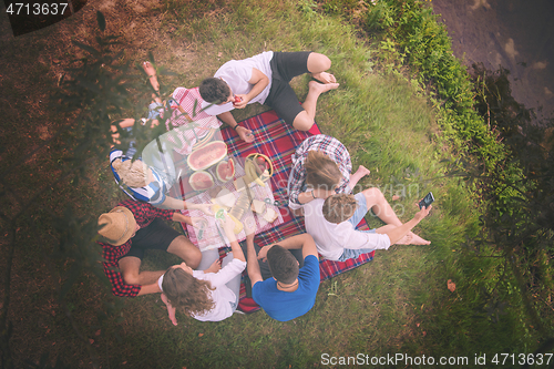 Image of top view of group friends enjoying picnic time