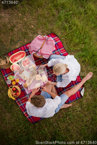 Image of top view of couple enjoying picnic time