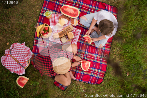 Image of top view of couple enjoying picnic time