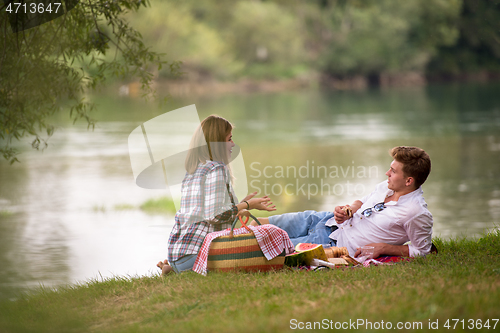 Image of Couple in love enjoying picnic time