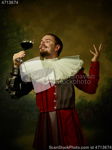 Image of Young man as a medieval knight on dark background