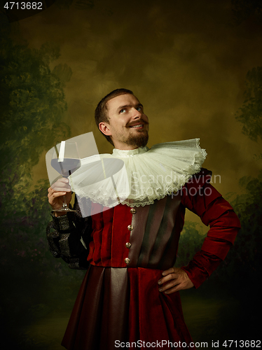 Image of Young man as a medieval knight on dark background