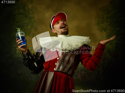 Image of Young man as a medieval knight on dark background