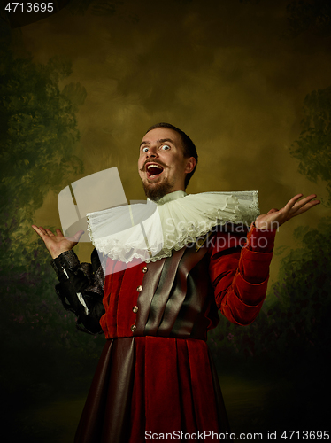 Image of Young man as a medieval knight on dark background