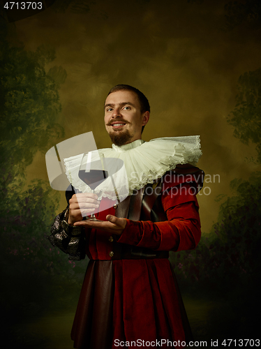 Image of Young man as a medieval knight on dark background