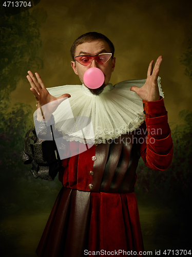 Image of Young man as a medieval knight on dark background