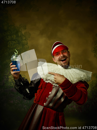 Image of Young man as a medieval knight on dark background