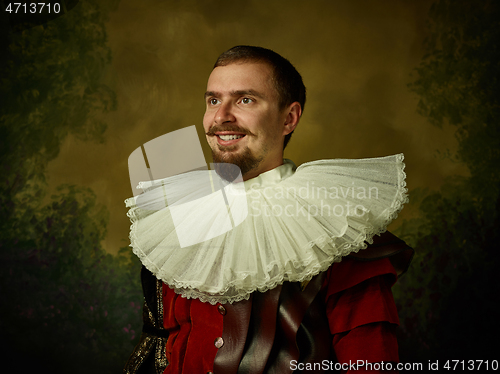 Image of Young man as a medieval knight on dark background