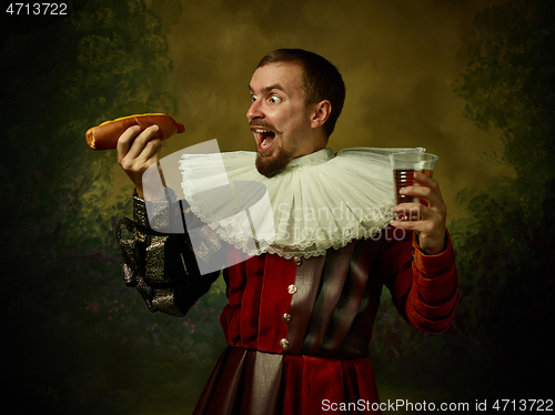 Image of Young man as a medieval knight on dark background