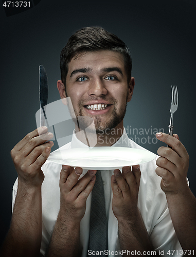 Image of A young man surrounded by hands like his own thoughts