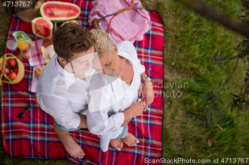 Image of top view of couple enjoying picnic time